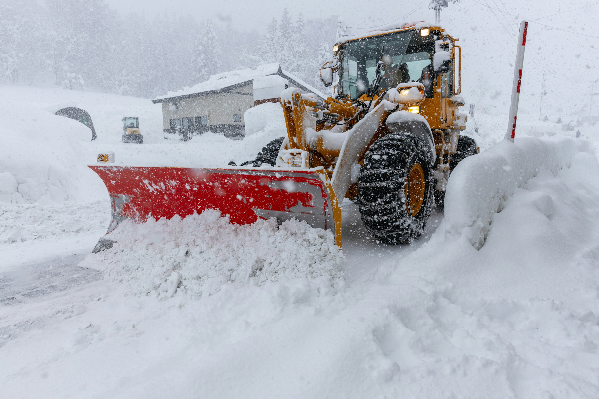 Heavy-duty snow removal equipment and salt spreader trucks prepared for winter maintenance services