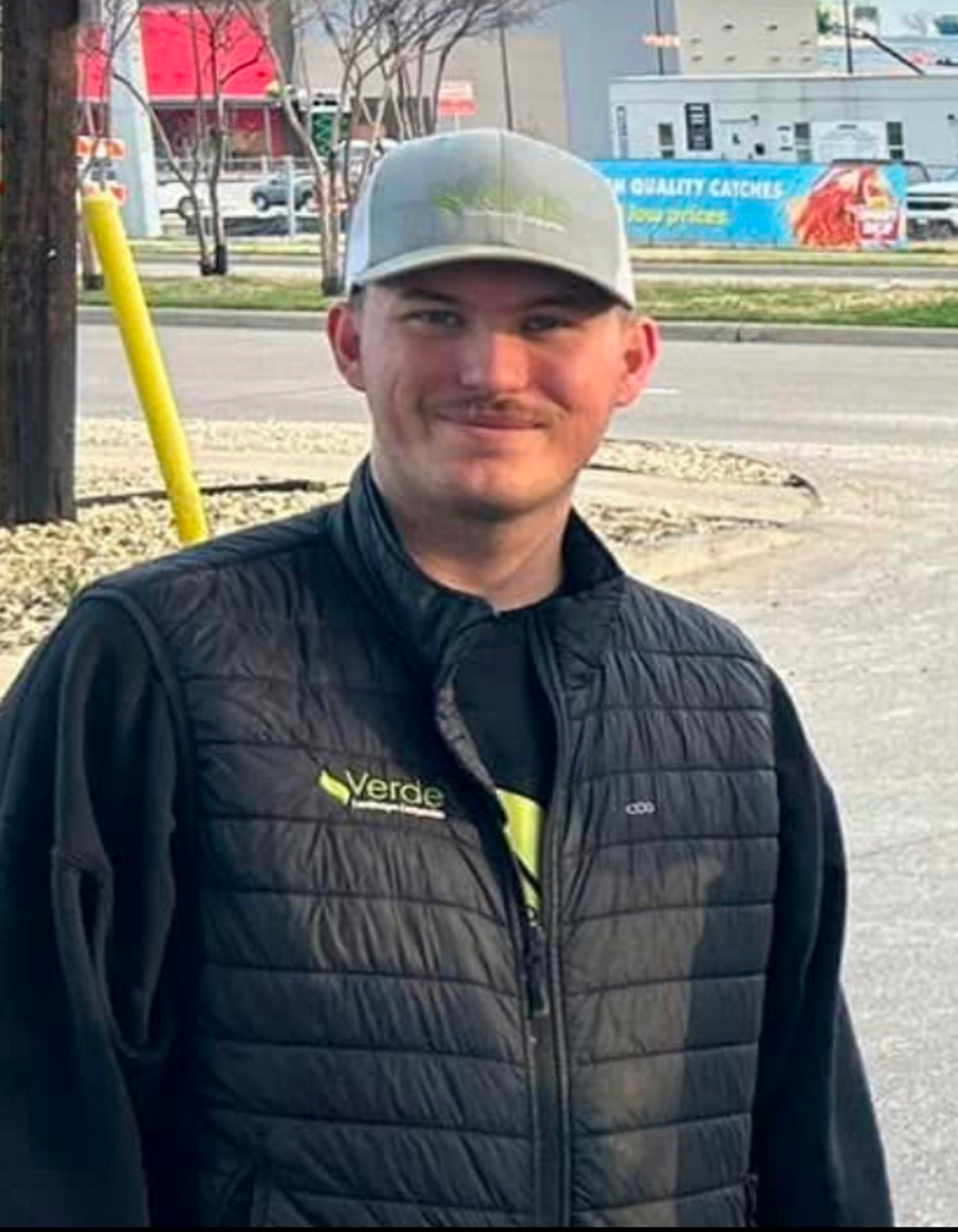 Professional headshot of Connor Kvapil, Verde Landscape's Lubbock Account Manager, displaying a friendly and confident demeanor in business attire