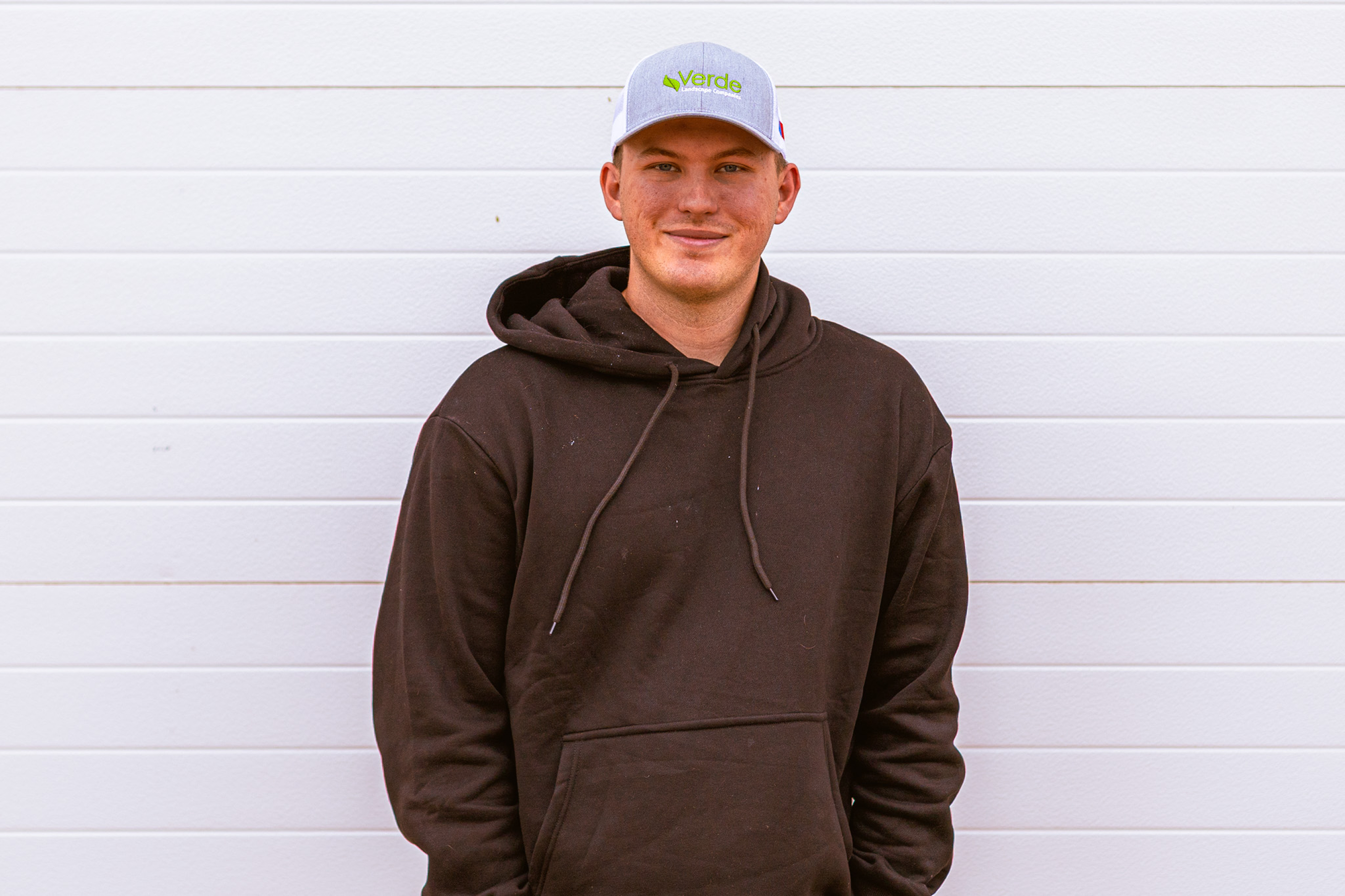 Professional headshot of Connor Kvapil, Verde Landscape's Lubbock Account Manager, displaying a friendly and confident demeanor in business attire
